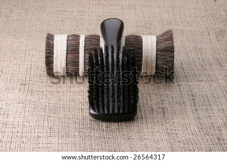 Men\'s comb. Expensive wooden comb lying on the cloth.