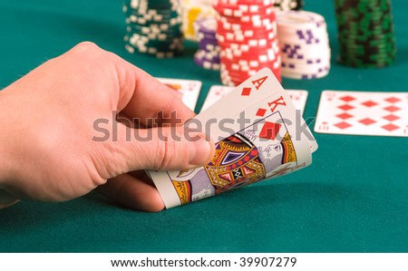 The player in poker looks the cards.