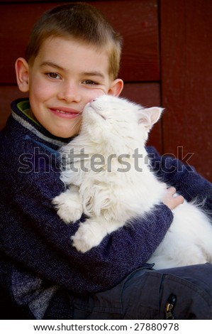 Portrait of the boy which holds on the hands a cat