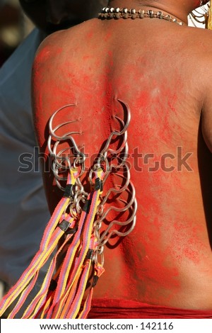 The practice of piercing the body with hooks in a Hindu religious event called Deepavali.