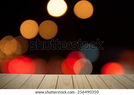 Winter bokeh background with empty wooden deck table. Christmas background. Ready for product montage display