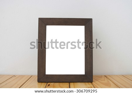 blank black picture frame on the wall and the floor