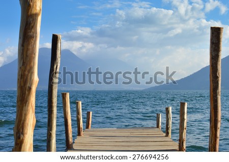 Boat dock at a small village of San Marcos on the Lake Atitlan in Guatemala with the volcanoes on the background