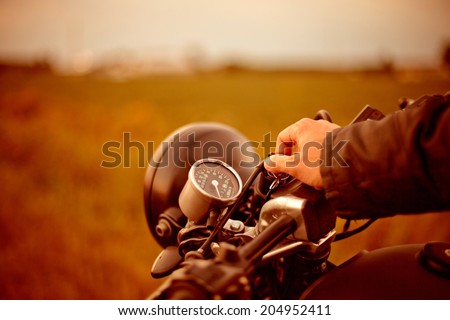 Biker starting old motorcycle