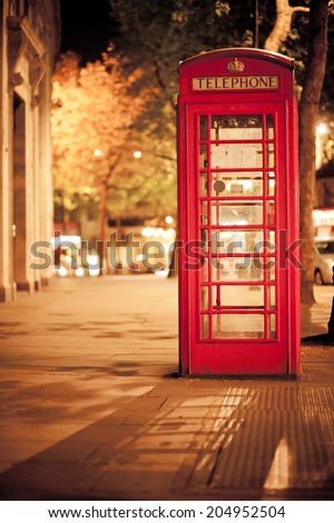 Typical London scene at night with phone booth. Short depth of field, focus on phone booth. Shot with 5DII high iso.