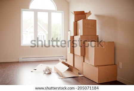 Pile of boxes being opened after moving. Short depth of field in natural light.