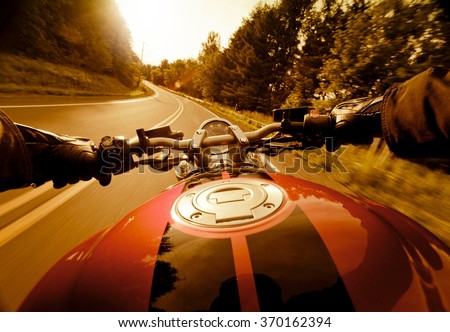 Riding motorcycle in the sunset.