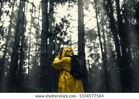 Man in a yellow raincoat with a camera. Wallpaper. Nice