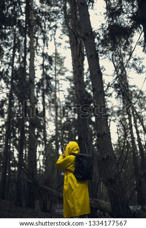 Man in a yellow raincoat with a camera. Mobile Wallpaper