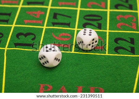 roll of the white dice on a game table in a casino