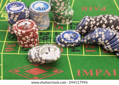 casino chips on green felt game table in a casino