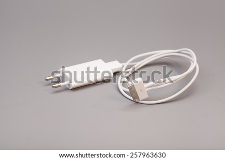 Electrical adapter to USB port on gray background