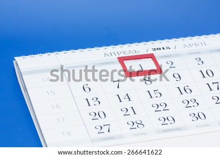 2015 year calendar. April calendar with red mark on framed date 1 isolated on blue background