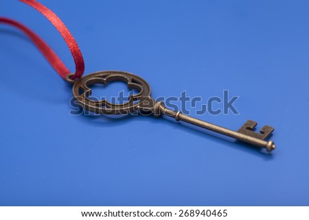 Key To Success With Red Bow isolated on blue background