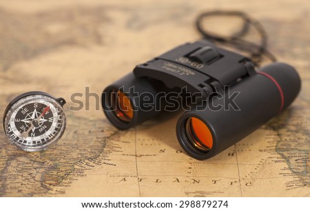 Binocular and compass on map