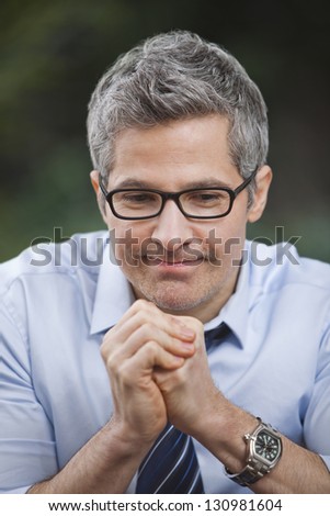 Businessman thinking with his hands clasped