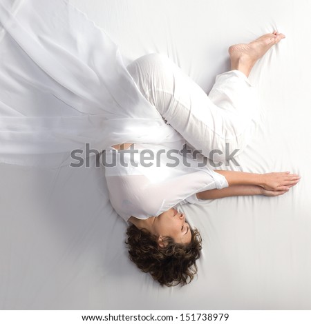Woman in fetal position on white background