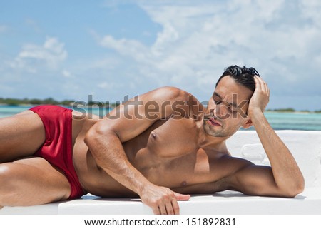 Man Sunbathing On The Beach