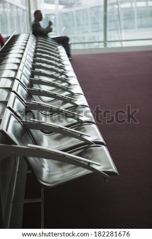 Empty chairs in lobby at an airport