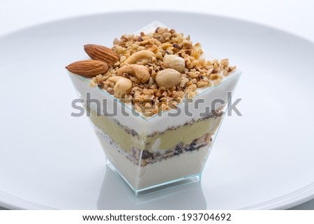 frozen yogurt cake with nuts in the cup nuts on the plate