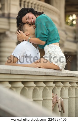 Sitting woman hugging a man