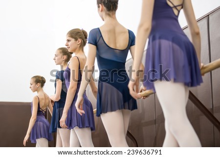 group of teenagers involved in choreographing the dance hall near the barre