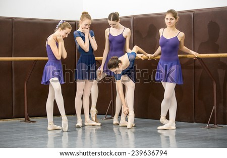 group of teenagers involved in choreographing the dance hall near the barre
