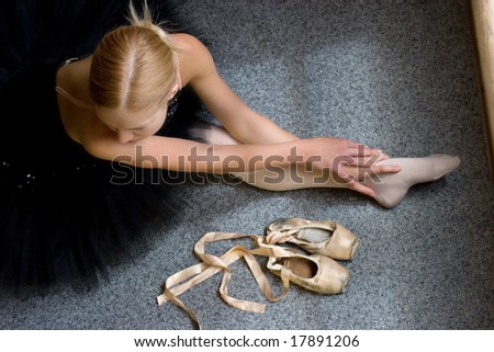 ballerina is relaxing on the floor in the room