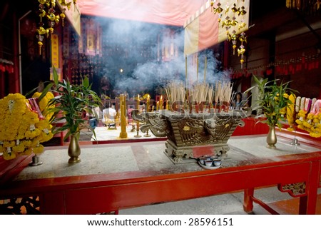 Joss sticks burn at an altar in temple