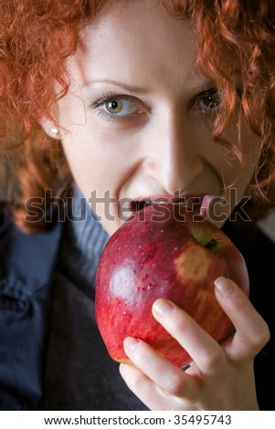 close-up of woman taking a bite of juicy fresh apple