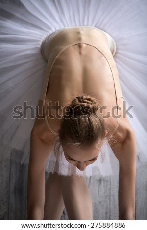 Ballerina in white tutu makes you lean forward. Top view.