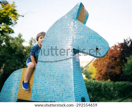 Little boy riding a toy horse ceramic tile