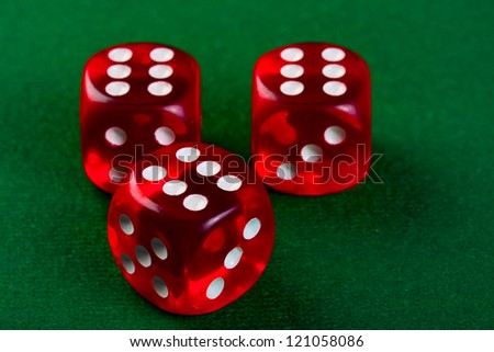 Group red dices on the green cloth.
