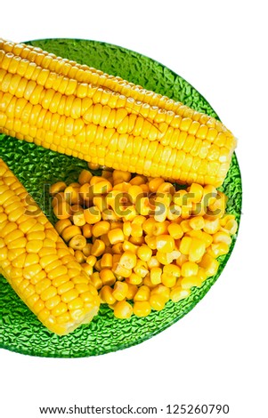 canned corn on green plate isolated on whiter background