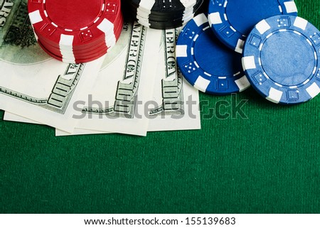 Group of chips and money on the green cloth.