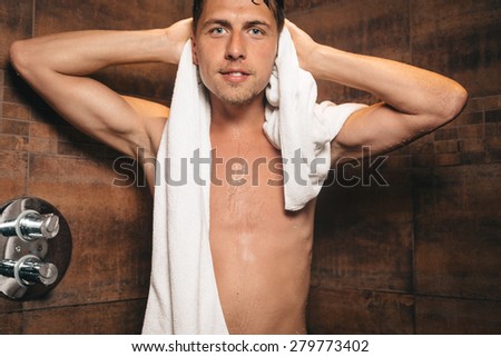 handsome young man with the towel in shower