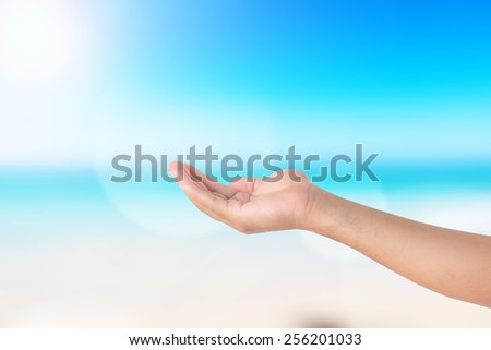 Human open empty hands with palms up. Blurred background.