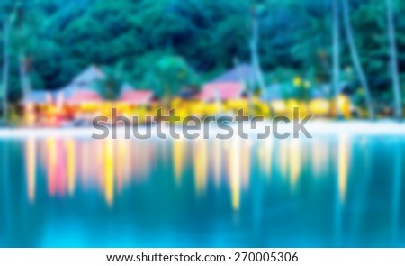 The restaurant\'s beautiful light shine into the water, blurring the background.