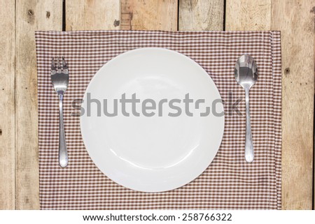 white empty dinner plate setting on table