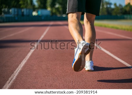 Running shoes, feet and legs. Young men running.
