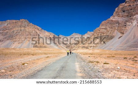 Three cyclist riding on mountains road. Himalayas, India