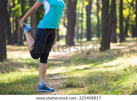 Runner woman training on forest road in beautiful nature. Caucasian female sport fitness model jogging training for marathon during outdoor workout.