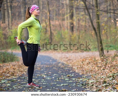 Runner woman training in park outdoor. Caucasian female sport fitness model jogging training for marathon during autumn outdoor workout.