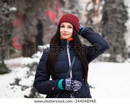 Young girl with long hear posing in winter frost park