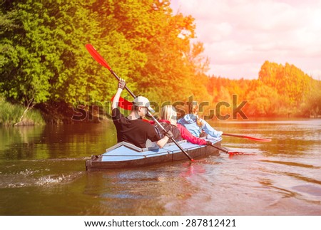 Young people are kayaking on a river in beautiful nature. Summer sunny day in outdoor