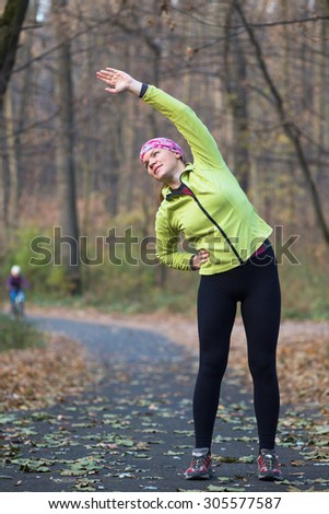 Sport woman doing stretching during outdoor cross training workout