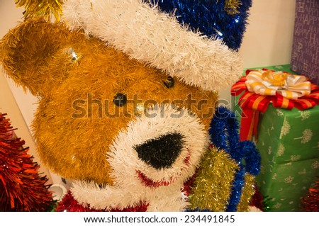 Teddy bear with Santa hat and Christmas gifts