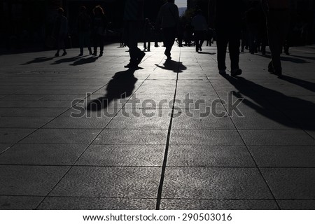 Shadows of people walking in a street of the city, Athens