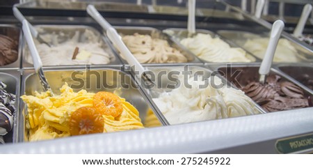Fresh mandarin ice cream and other flavors on the bench of an ice-cream shop