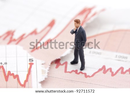 Financial crisis. Figure of businessman on financial charts
